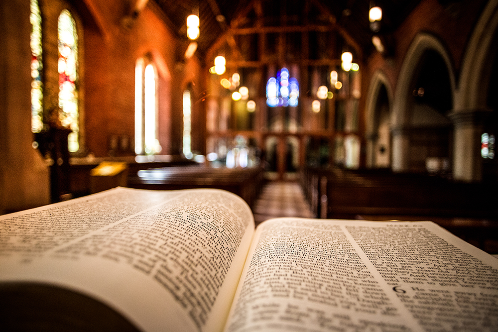 Holy_Bible_on_Altar_inside_illuminated_church