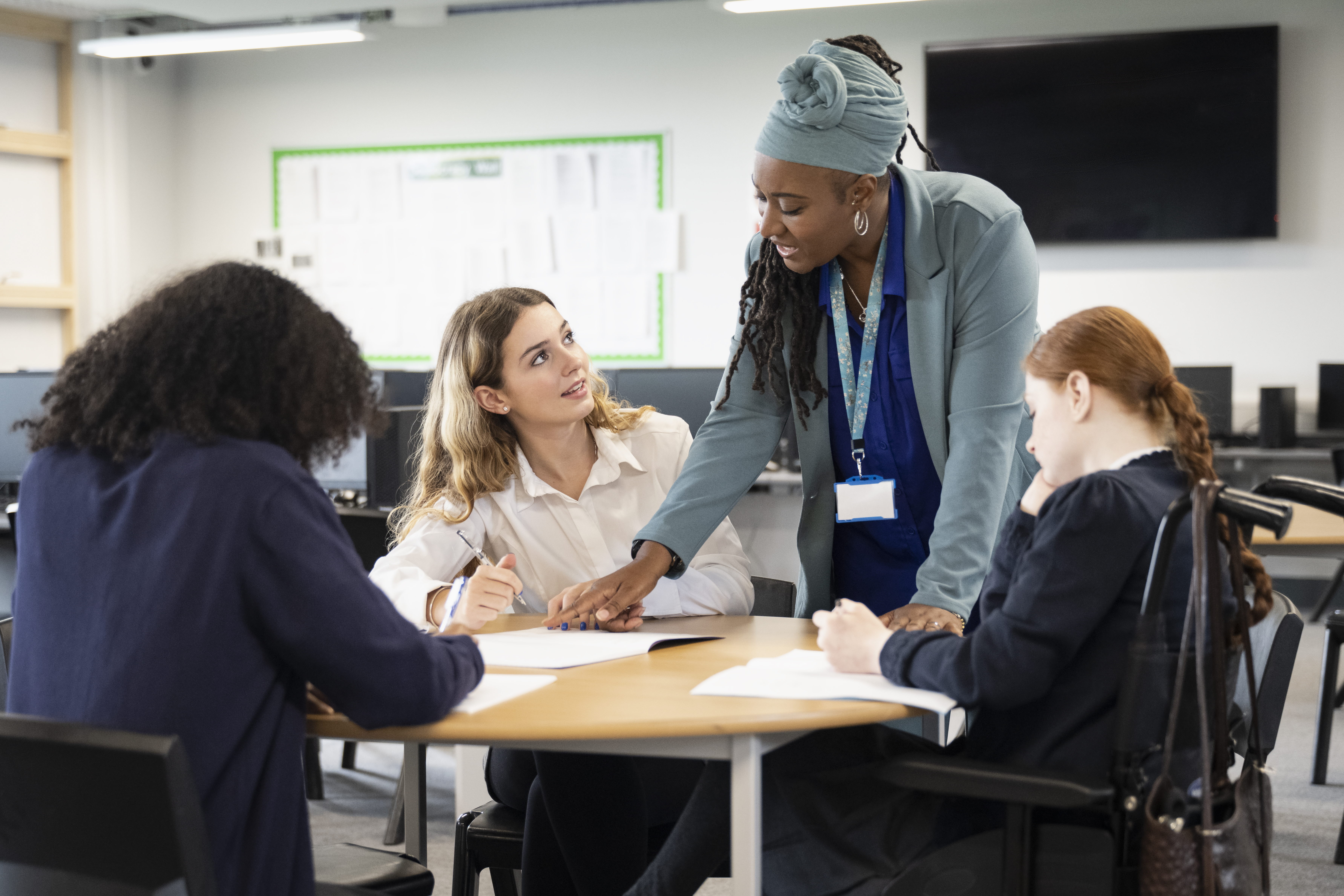 teacher_students_working_on_assignment